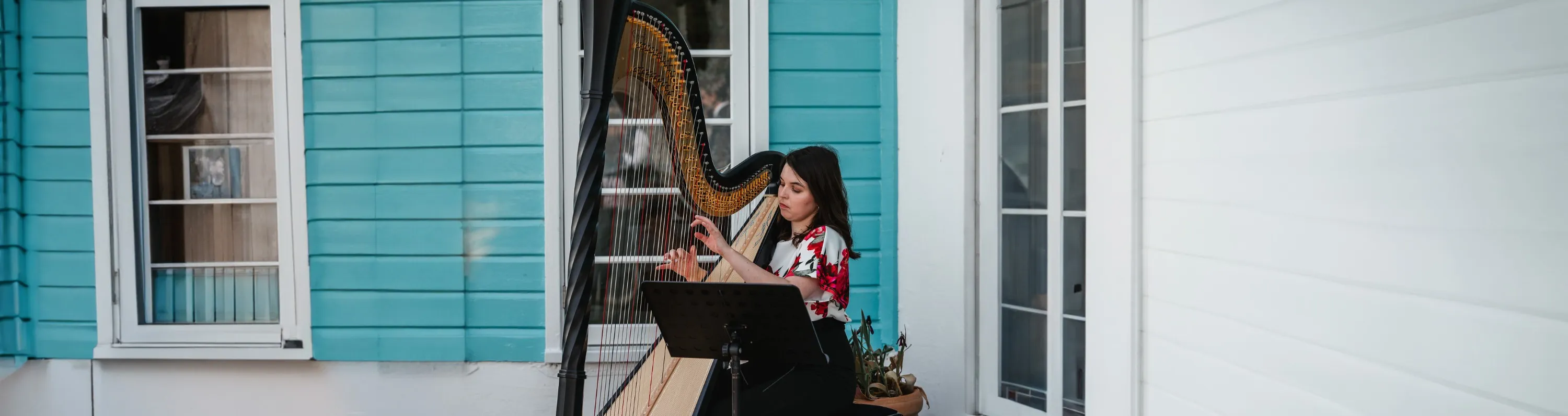 Angharad playing with a beach house in the background.